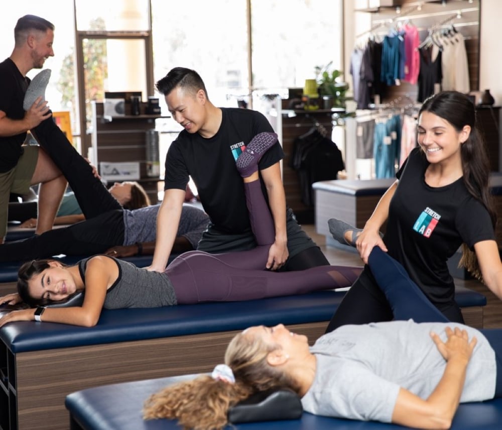 People receiving a 1-on-1 stretching service