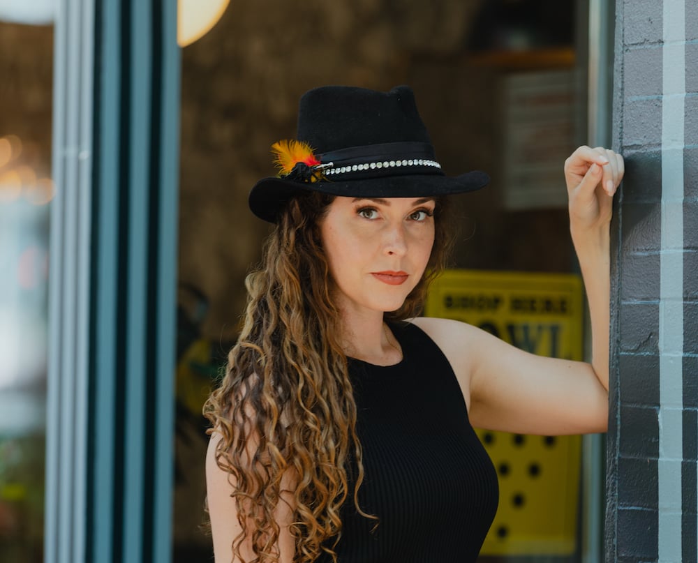 A woman wearing a stylish hat